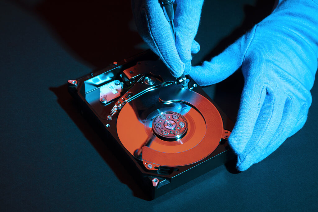 high angle hands with gloves working hard disk